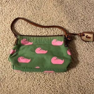 Green with pink ducks and leather handle. Hot pink interior